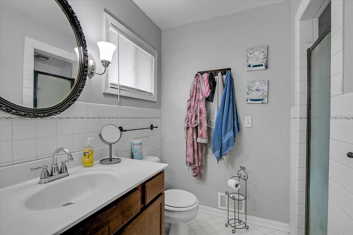1708 Montague Road Rockford, IL 61102 - Photo 26 of 39 a bathroom with a toilet sink and mirror