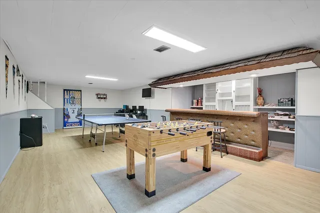 a living room with furniture a fireplace and a view of kitchen