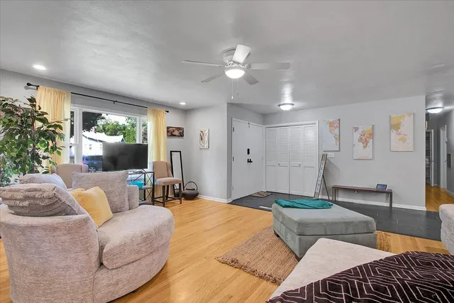 a bedroom with a bed a couch and potted plant