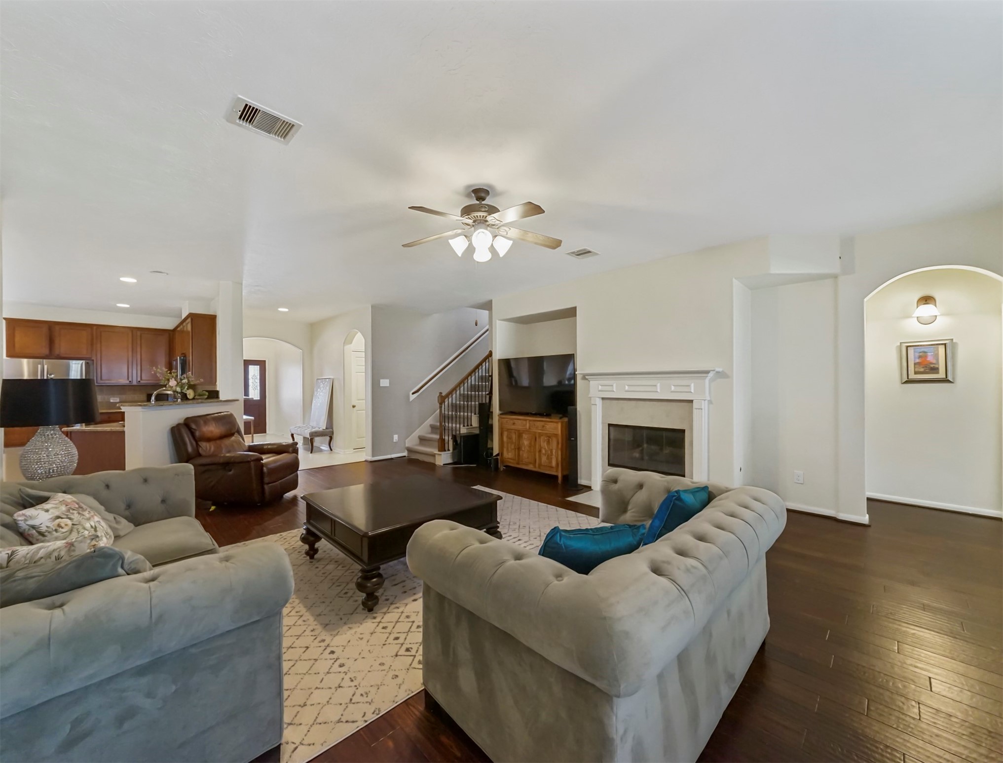 8214 Garrison Point Drive Houston, TX 77040 - Photo 12 of 37 a living room with furniture a fireplace and a flat screen tv