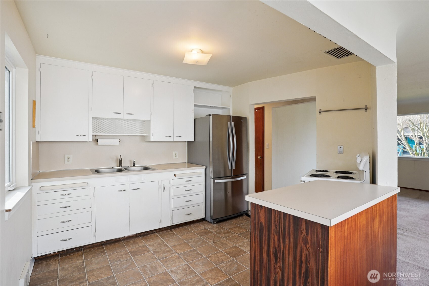 6628 Flora Avenue South Seattle, WA 98108 - Photo 9 of 32 a kitchen with stainless steel appliances a stove refrigerator sink and cabinets