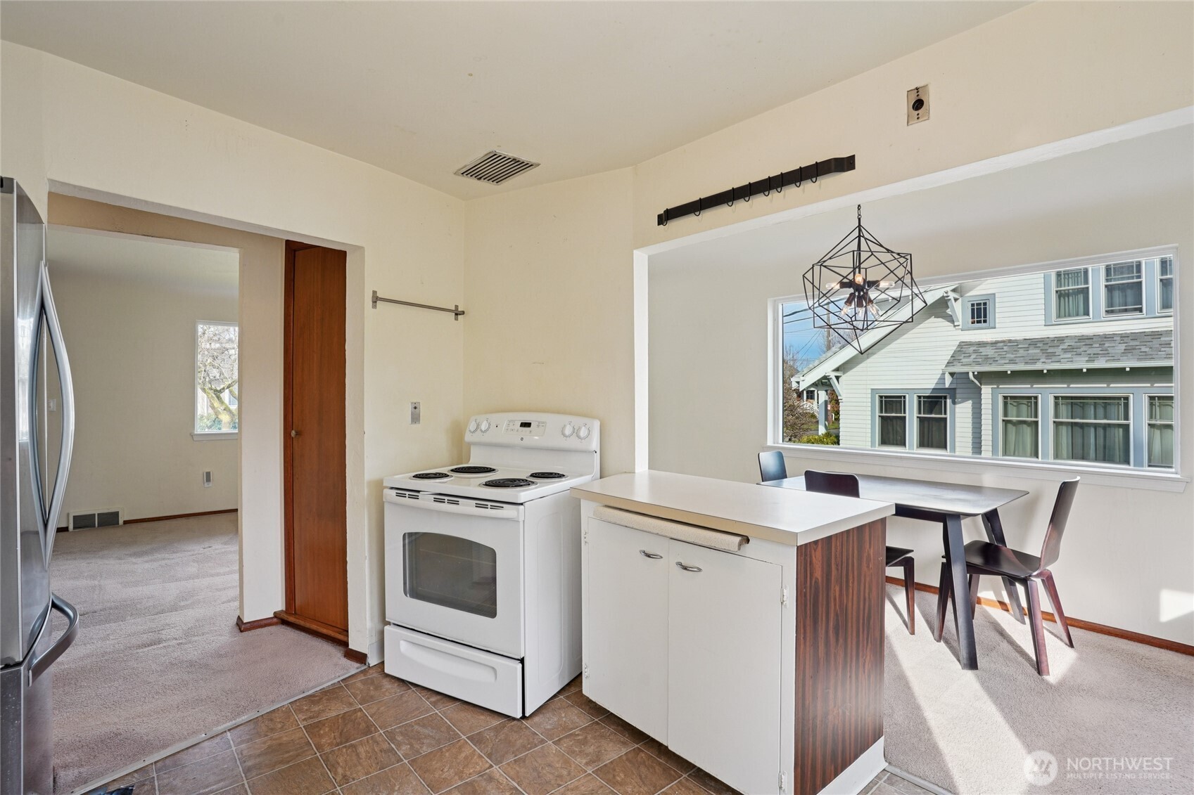 6628 Flora Avenue South Seattle, WA 98108 - Photo 10 of 32 a kitchen with a stove top oven and cabinets