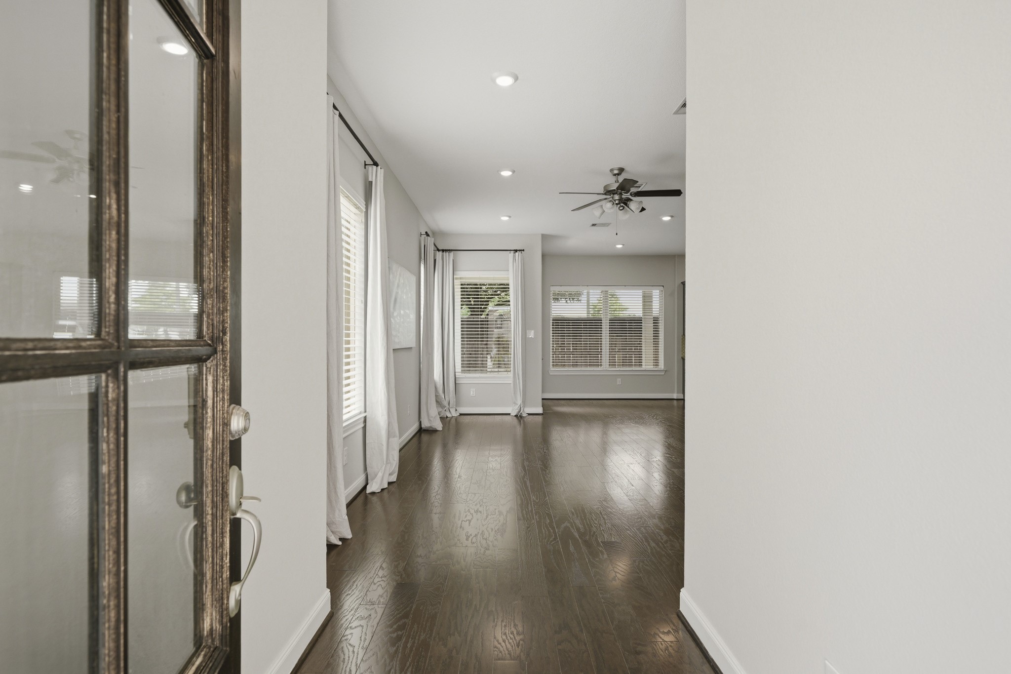 4103 Tranquil Square Road Houston, TX 77043 - Photo 3 of 39 An elegant 8-foot glass front door paired with tailored Roman shades introduces a designed interior anchored by rich hardwood flooring.