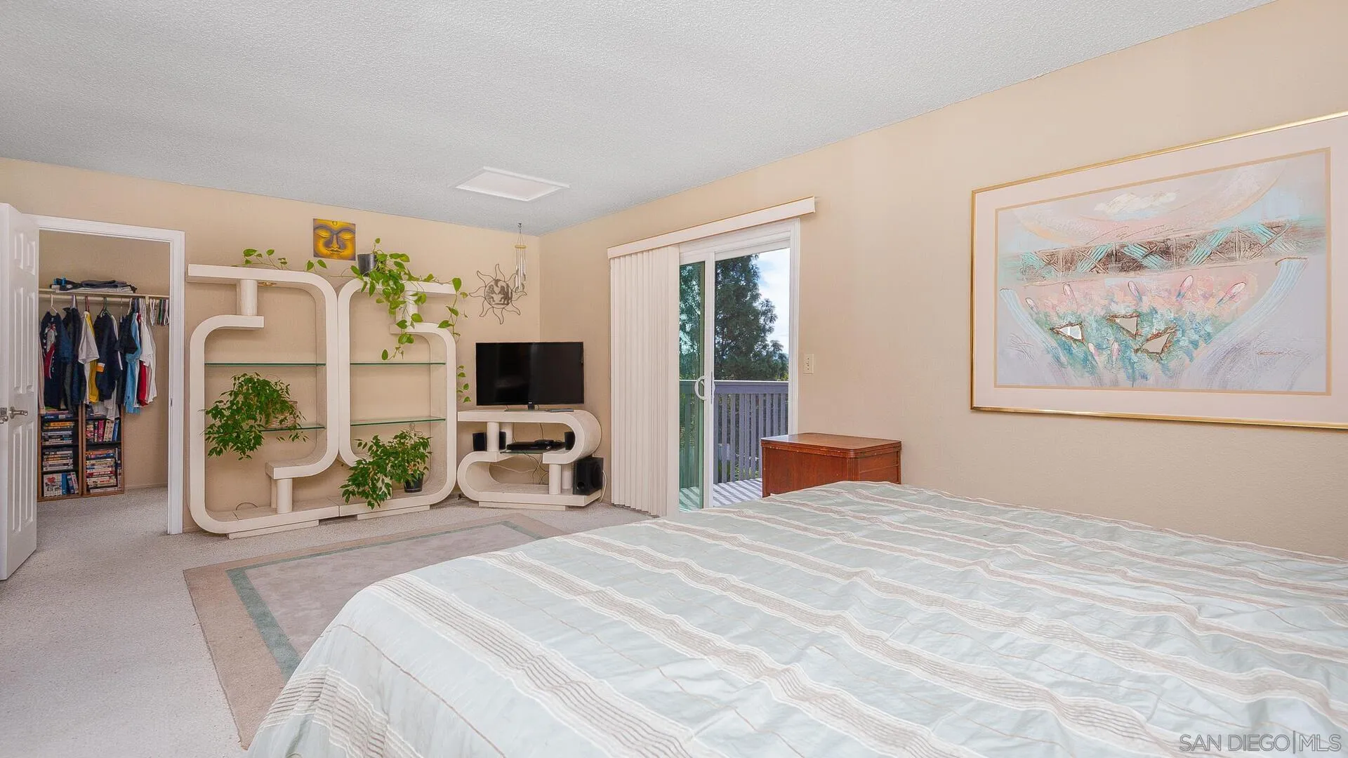 9648 Ramsgate Way Santee, CA 92071 - Photo 17 of 42 a bedroom with a large bed and a flat screen tv
