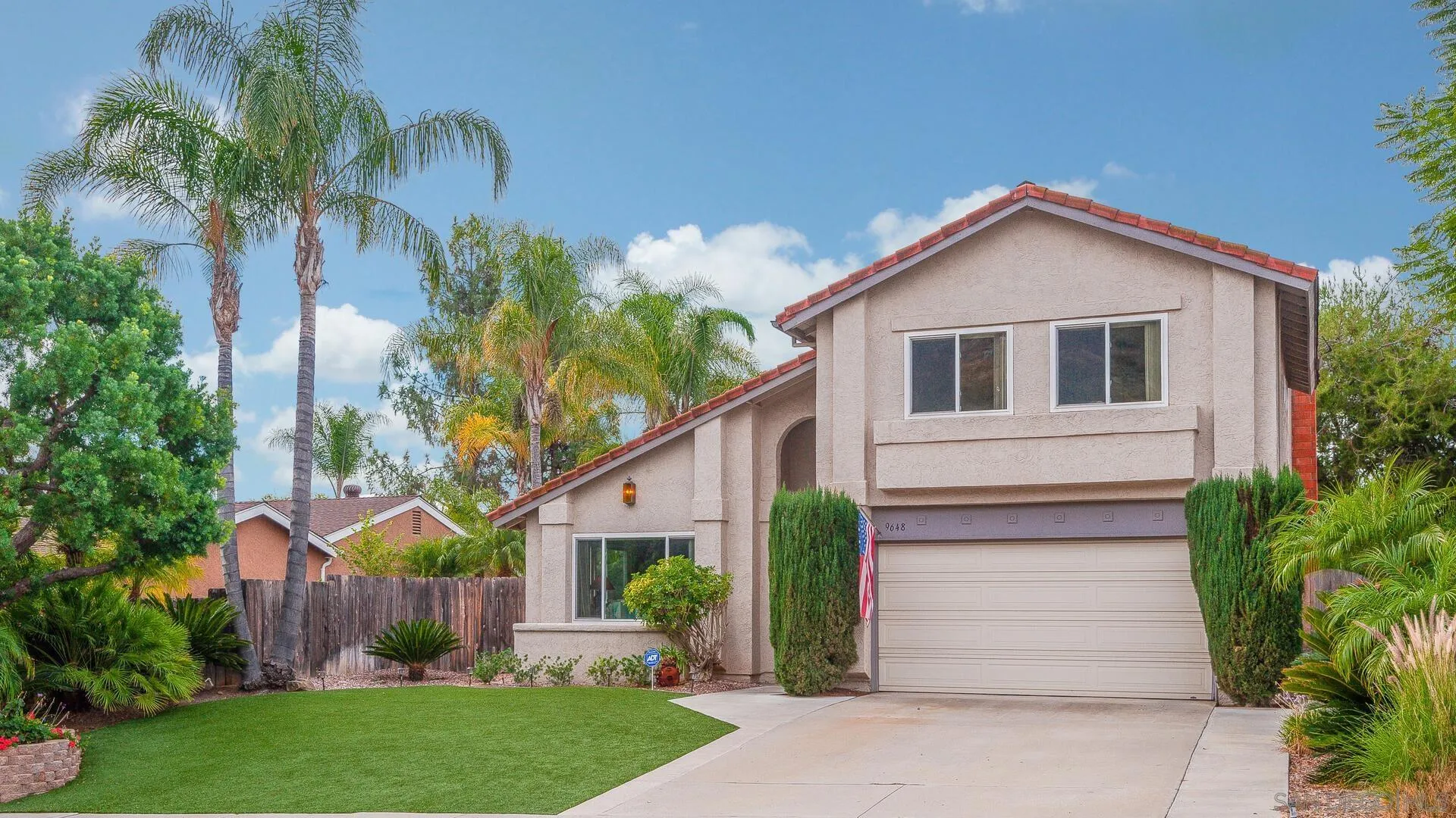9648 Ramsgate Way Santee, CA 92071 - Photo 42 of 42 a front view of a house with a yard and garage