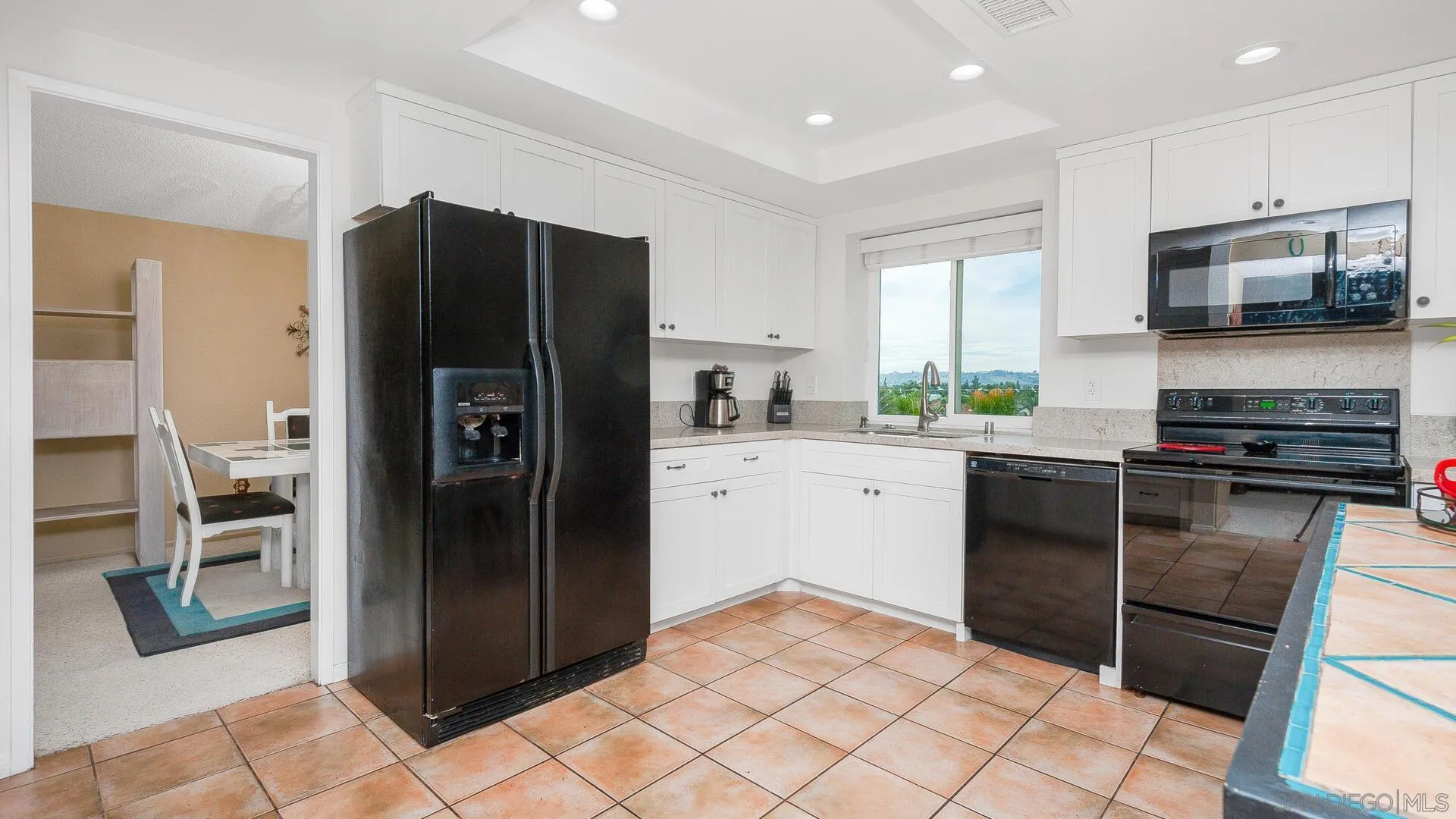 9648 Ramsgate Way Santee, CA 92071 - Photo 8 of 42 a kitchen with a refrigerator and a stove top oven