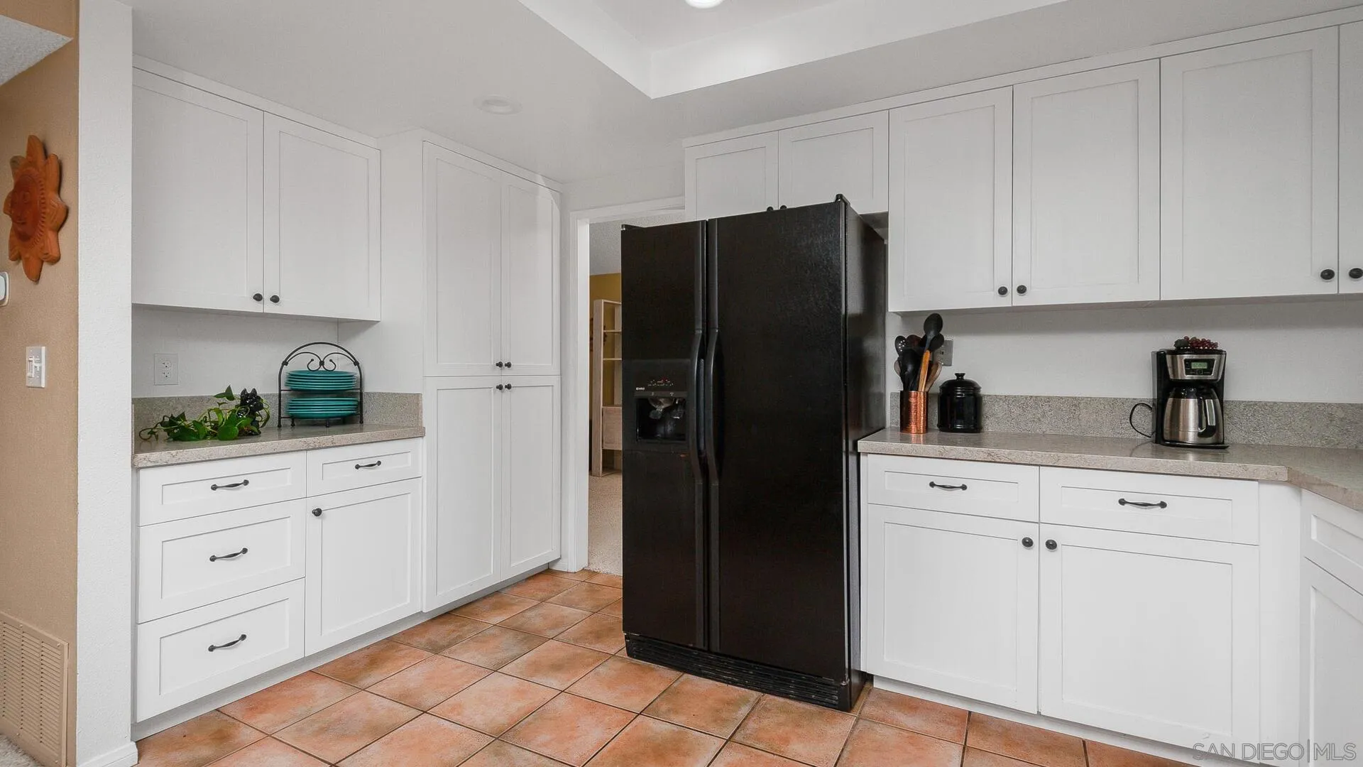 9648 Ramsgate Way Santee, CA 92071 - Photo 9 of 42 a kitchen with white cabinets and refrigerator