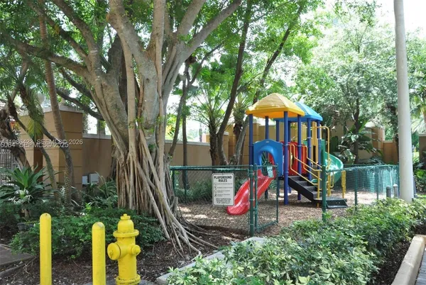 a view of a park with iron fence