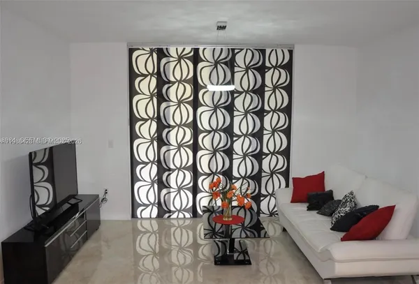 a bedroom with a couch and a wall painting