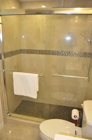 a bathroom with a toilet and a shower