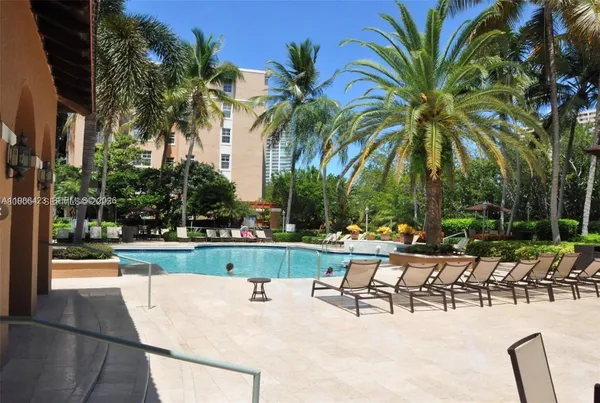 a view of swimming pool with outdoor seating and plants