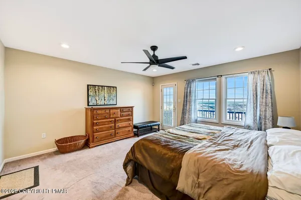 a bedroom with two beds and a window