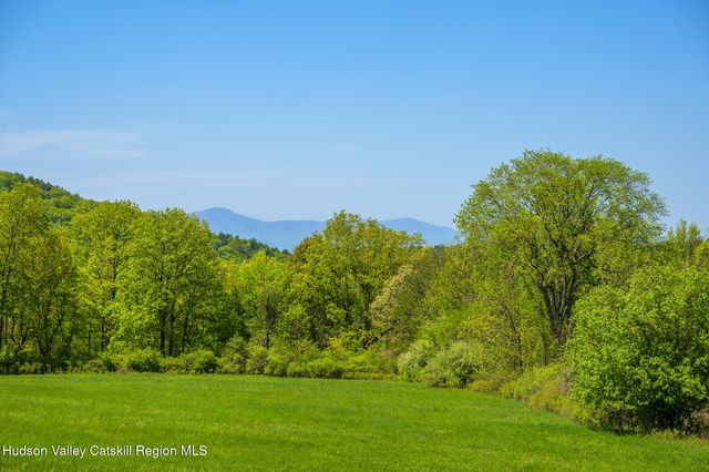 a living room with furniture and large windows