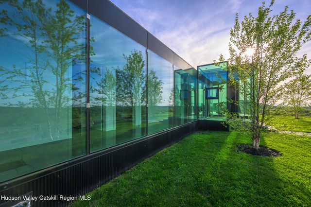 a bathroom with a glass door shower and a sink