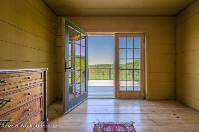 a view of a balcony with chairs and wooden floor