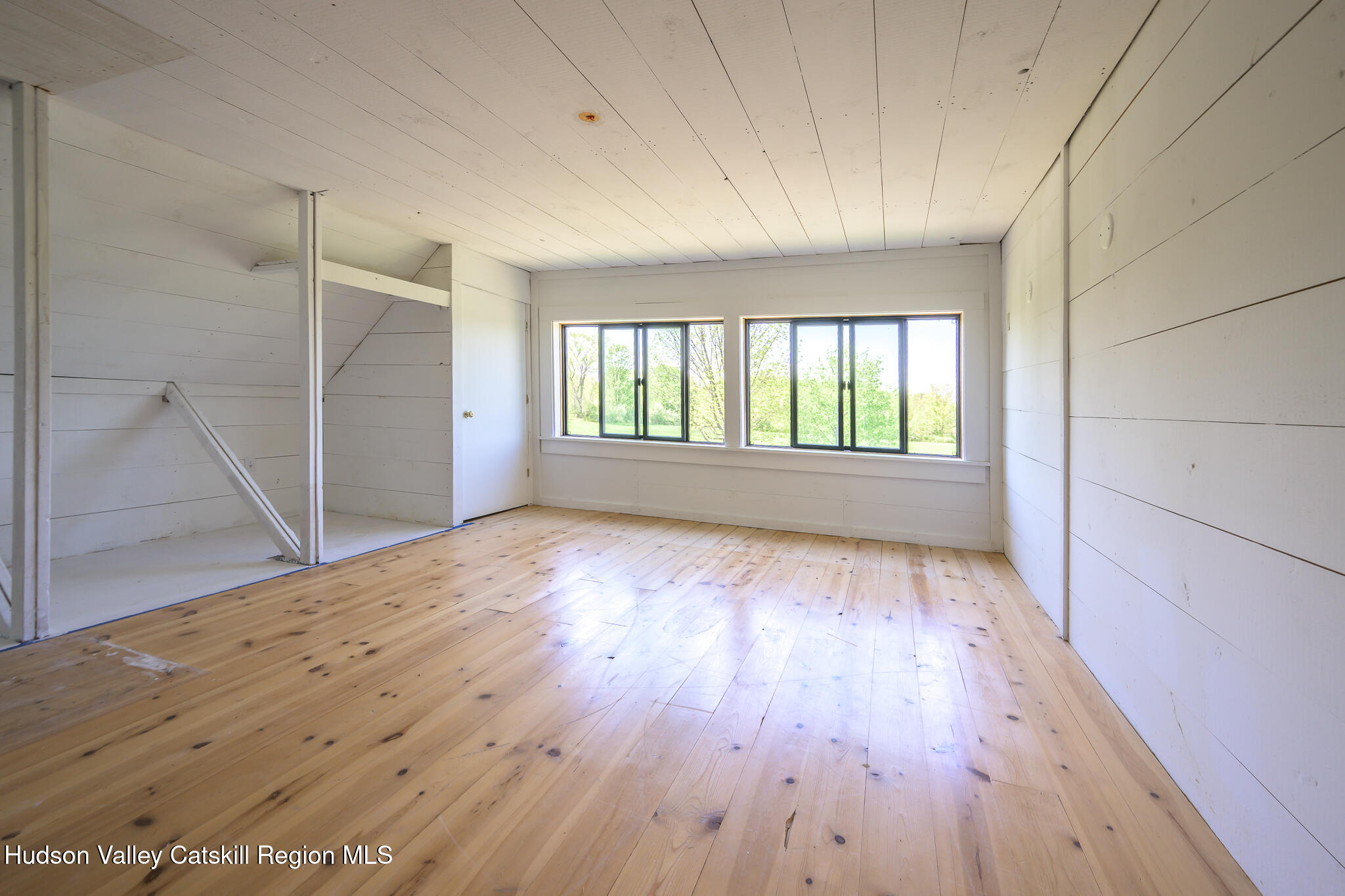837 Carlson Road Craryville, NY 12521 - Photo 48 of 65 wooden floor in an empty room with a window