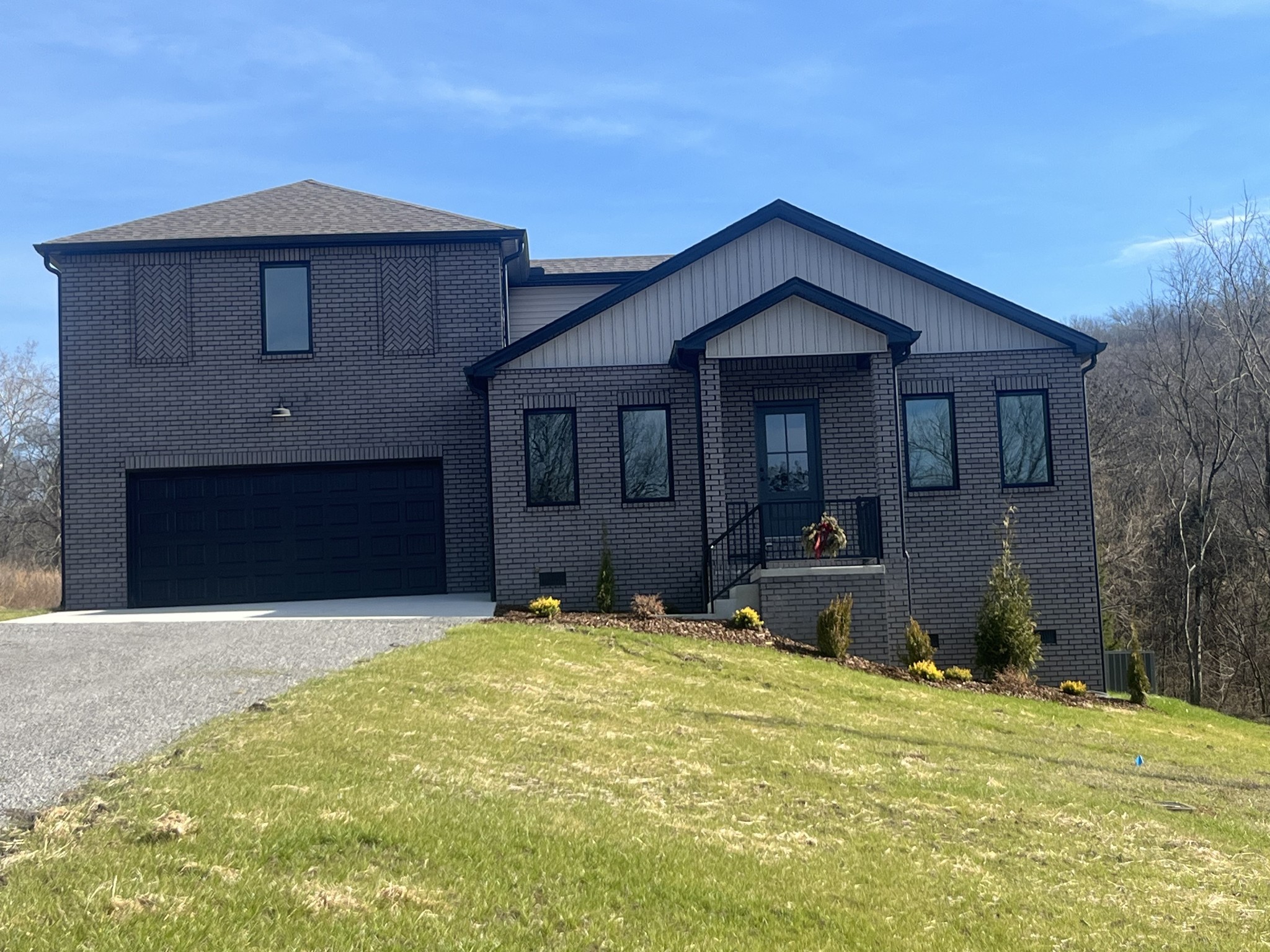 a view of a house with a yard and wooden fence