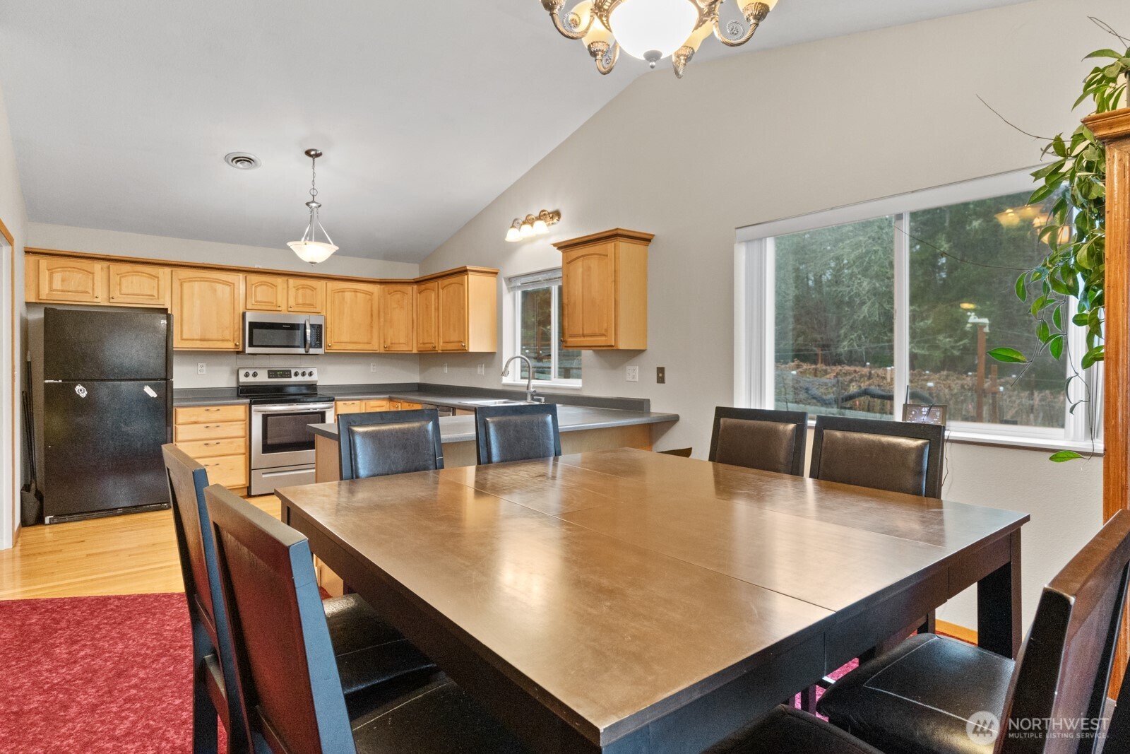 244 Martin Road Glenoma, WA 98336 - Photo 18 of 39 a large kitchen with a table chairs and flat screen tv