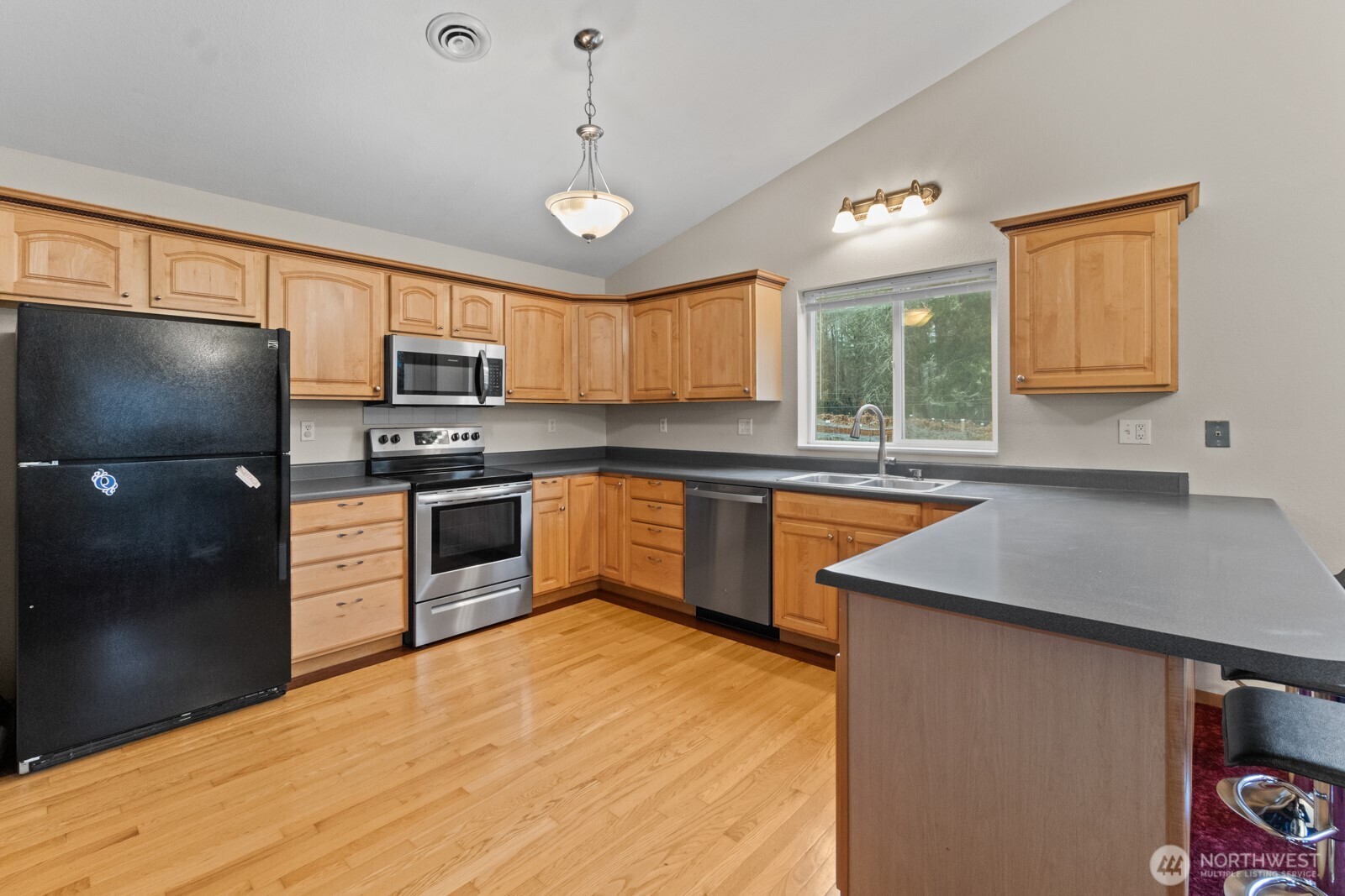 244 Martin Road Glenoma, WA 98336 - Photo 19 of 39 a kitchen with stainless steel appliances granite countertop a sink refrigerator stove and microwave
