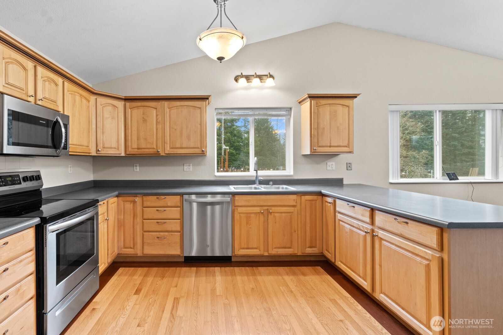 244 Martin Road Glenoma, WA 98336 - Photo 20 of 39 a kitchen with stainless steel appliances granite countertop wooden cabinets a stove top oven a sink and dishwasher a oven with wooden floor