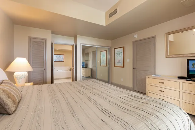 a bathroom with a tub a double vanity sink and a mirror