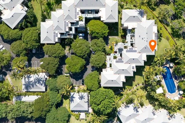 an aerial view of a house with a yard and garden