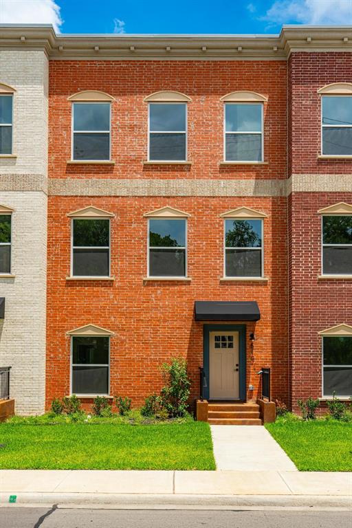 510 South O Connor Road Irving, TX 75060 - Photo 1 of 22 Three-story brick facade featuring multiple windows with decorative lintels, a light-colored entry door with overhead awning, and a concrete walkway to the entrance