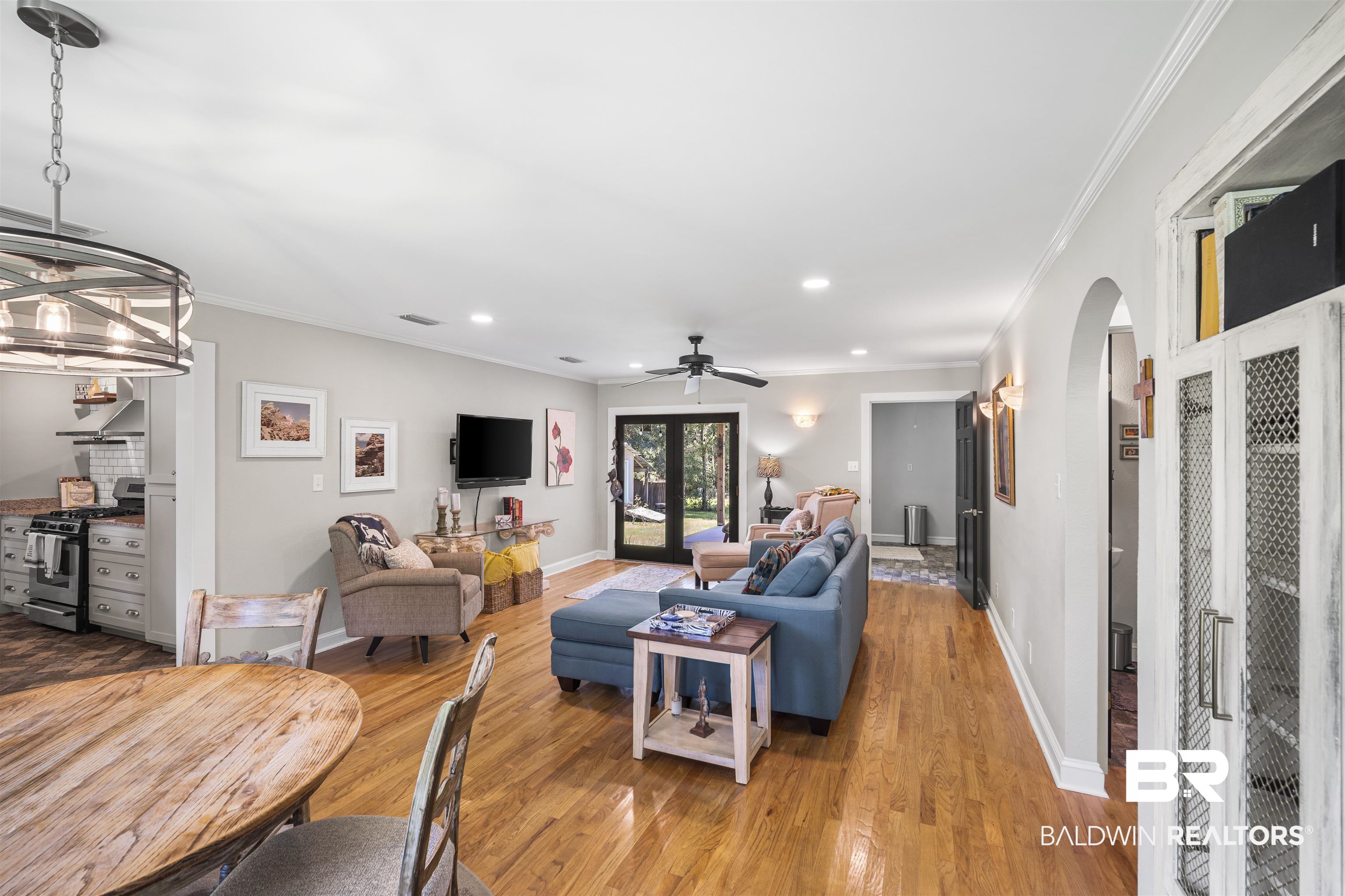 1615 5th Street Daphne, AL 36526 - Photo 11 of 28 Open-concept living area featuring wood-finish flooring, a contemporary ceiling fan, recessed lighting, and crown molding
