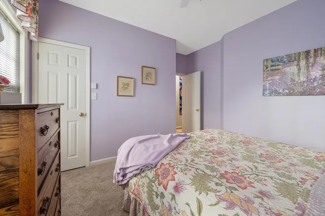 a bedroom with a bed and a fireplace