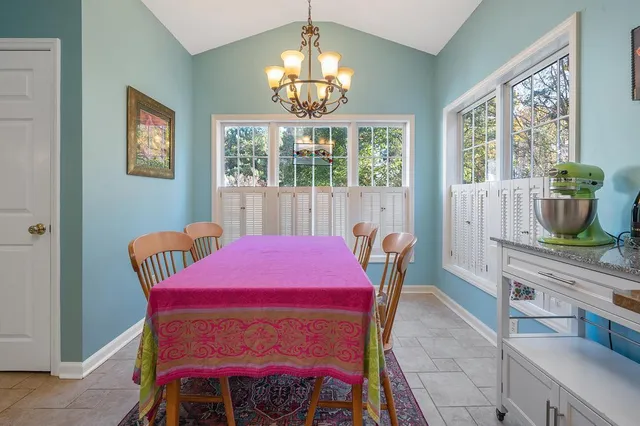 a dining room with furniture and window