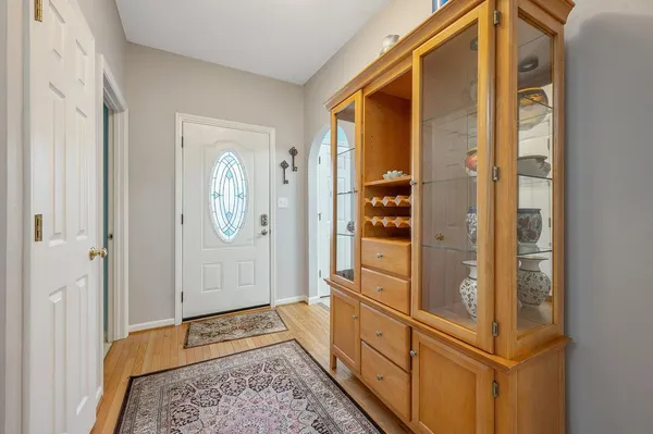 a hallway with wooden floor and windows