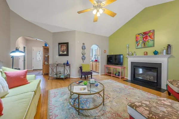a living room with furniture a flat screen tv and a fireplace