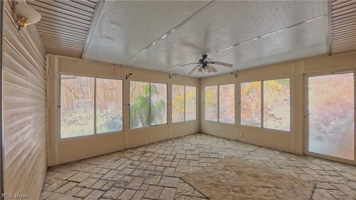 48276 Dyke Road Negley, OH 44441 - Photo 23 of 30 Unfurnished sunroom featuring a ceiling fan