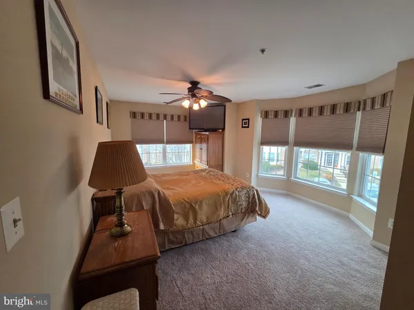 a spacious bedroom with a bed and a window