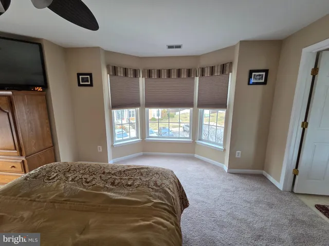 a bed sitting in a room next to a window