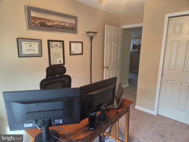 a view of workspace with wooden floor and windows