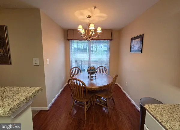 a dining room with furniture and chandelier