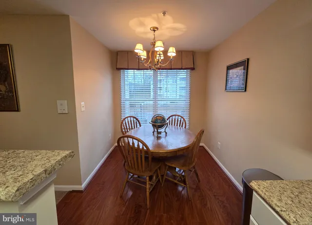 a dining room with furniture and chandelier