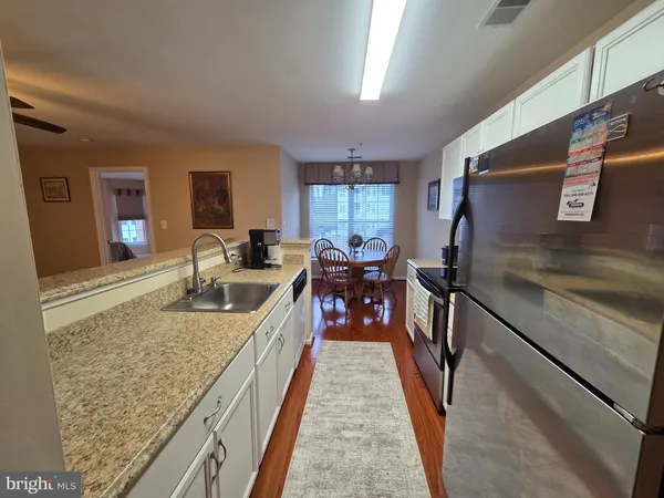 a kitchen with sink stove and cabinets