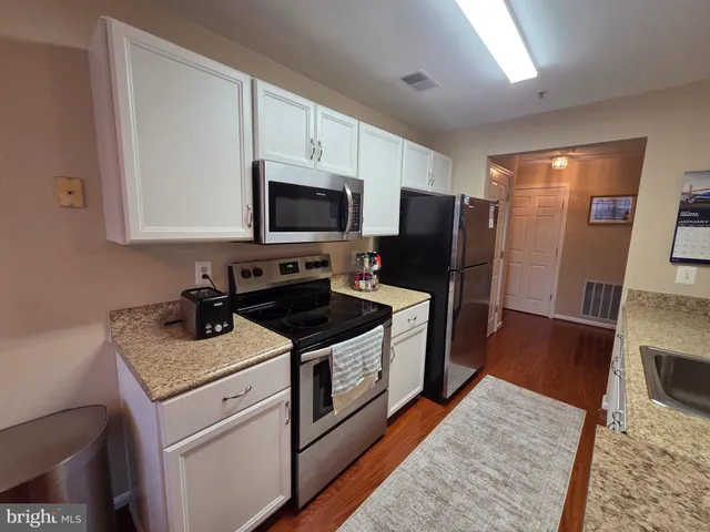 a kitchen with a stove microwave and refrigerator