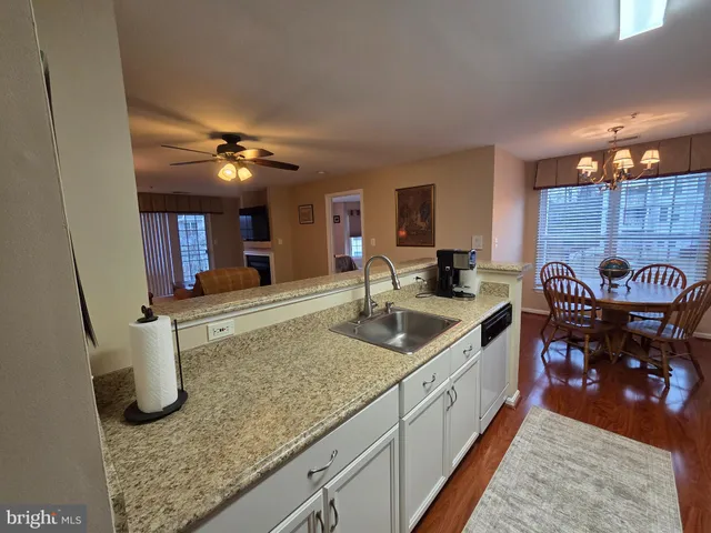 a kitchen with stainless steel appliances granite countertop a sink and a counter top space