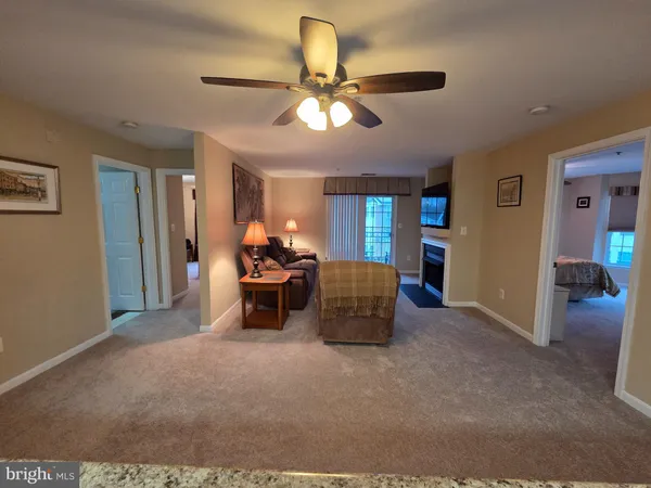 a view of a livingroom with furniture and a ceiling fan