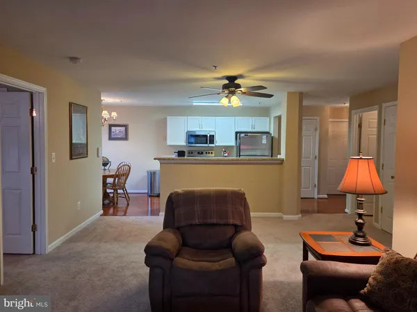 a living room with furniture and a lamp