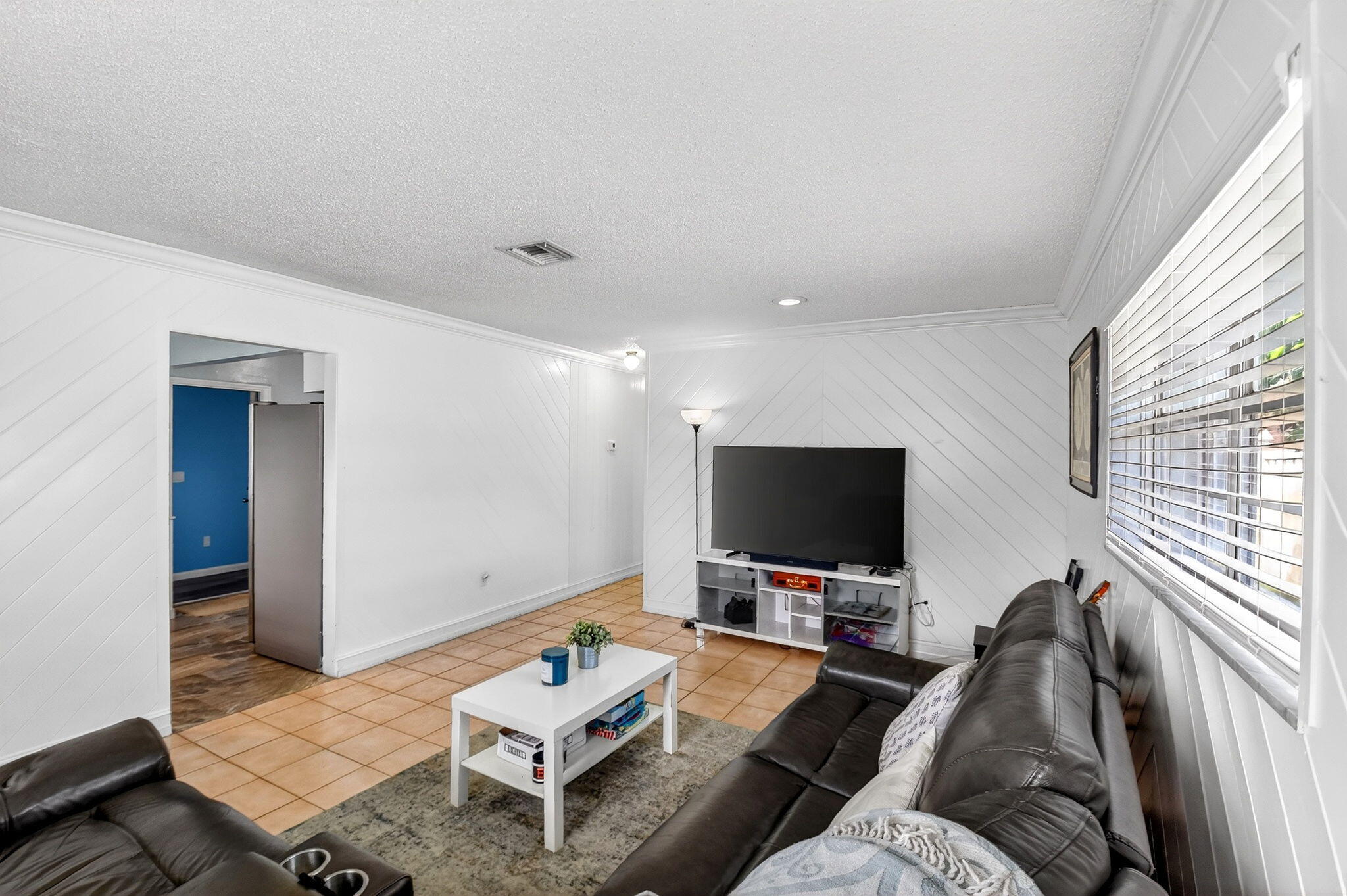 5721 Coconut Road West Palm Beach, FL 33413 - Photo 11 of 41 a living room with furniture and a flat screen tv