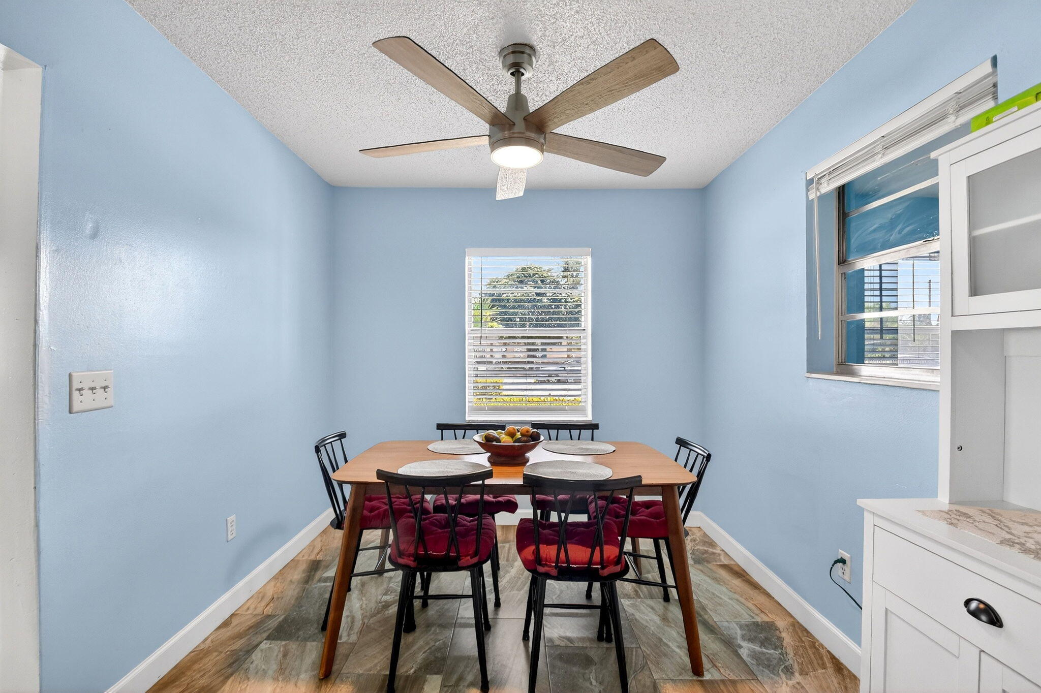 5721 Coconut Road West Palm Beach, FL 33413 - Photo 13 of 41 a view of a dining room with furniture window and wooden floor