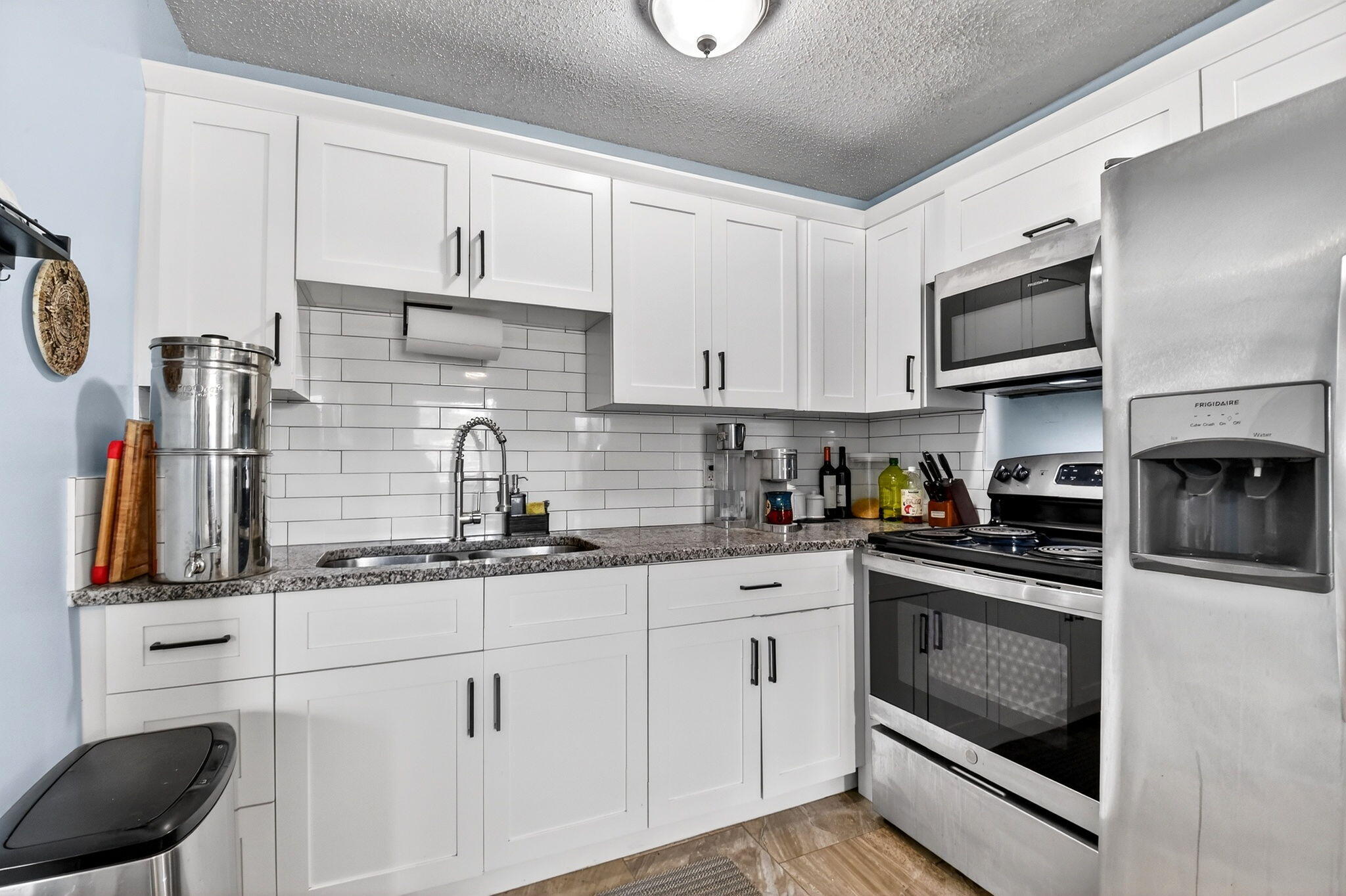 5721 Coconut Road West Palm Beach, FL 33413 - Photo 15 of 41 a kitchen with stainless steel appliances granite countertop a sink stove and cabinets