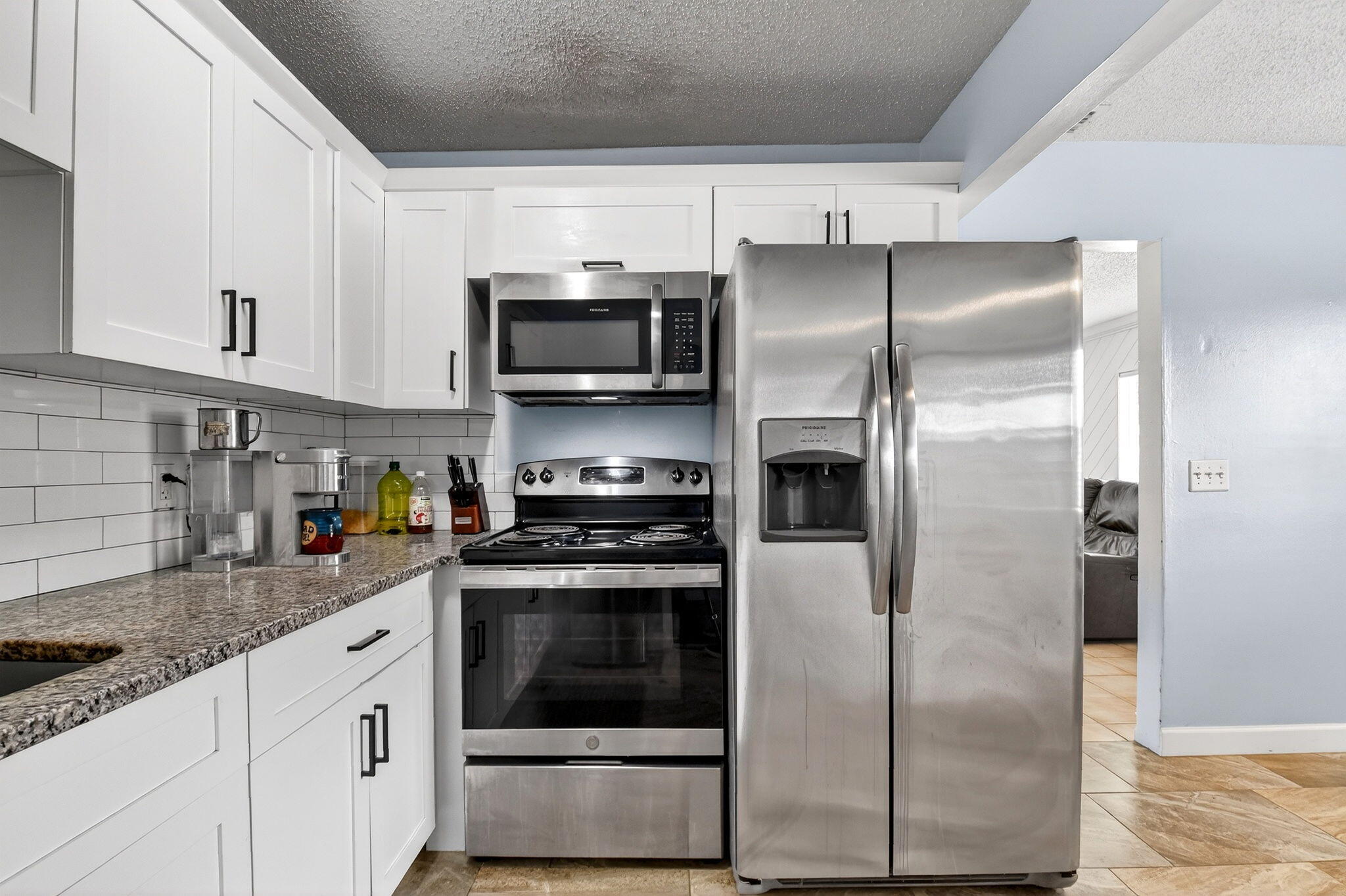 5721 Coconut Road West Palm Beach, FL 33413 - Photo 16 of 41 a kitchen with stainless steel appliances cabinets a sink and a counter top space