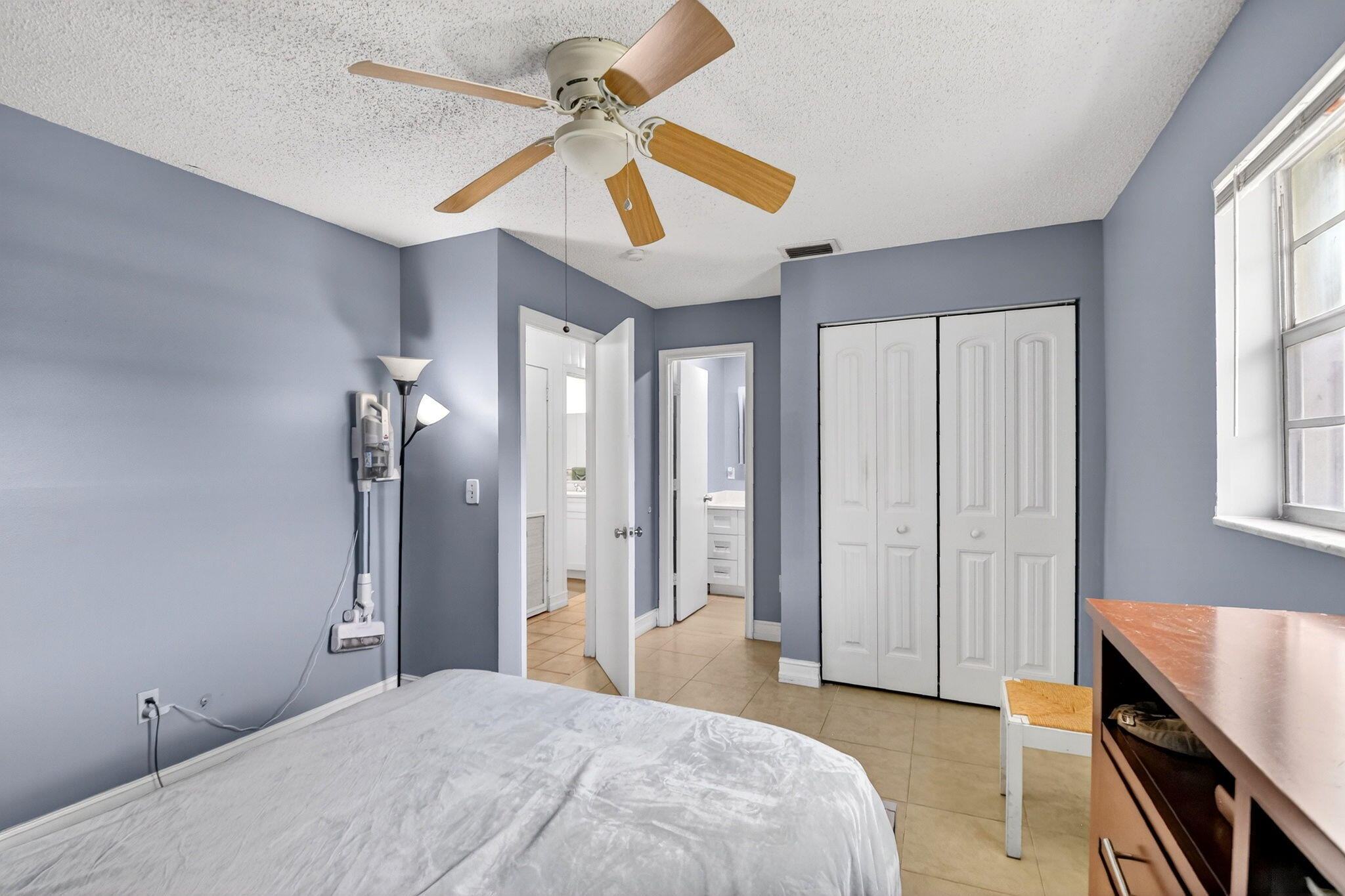 5721 Coconut Road West Palm Beach, FL 33413 - Photo 27 of 41 a bedroom with a bed and a chandelier