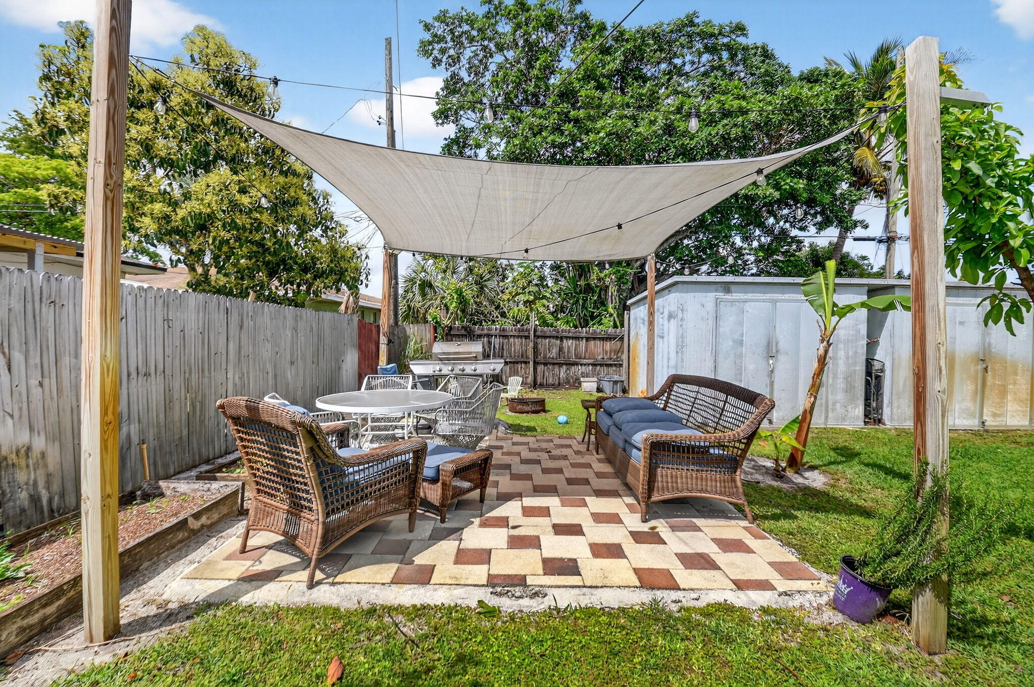 5721 Coconut Road West Palm Beach, FL 33413 - Photo 29 of 41 a view of a patio with a table chairs and a backyard