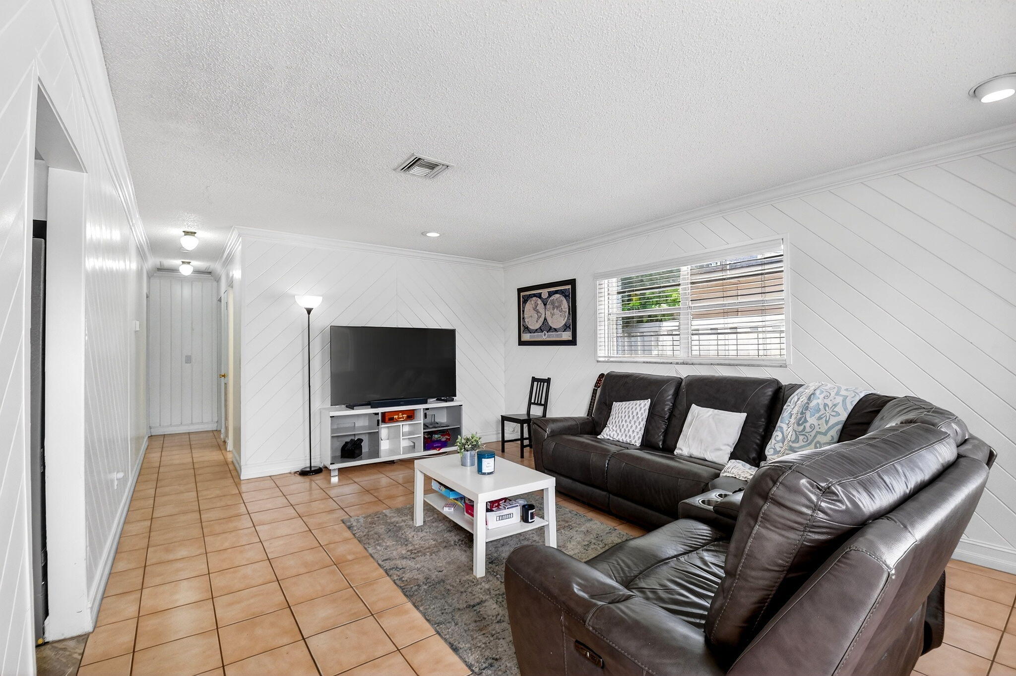 5721 Coconut Road West Palm Beach, FL 33413 - Photo 3 of 41 a living room with furniture and a flat screen tv